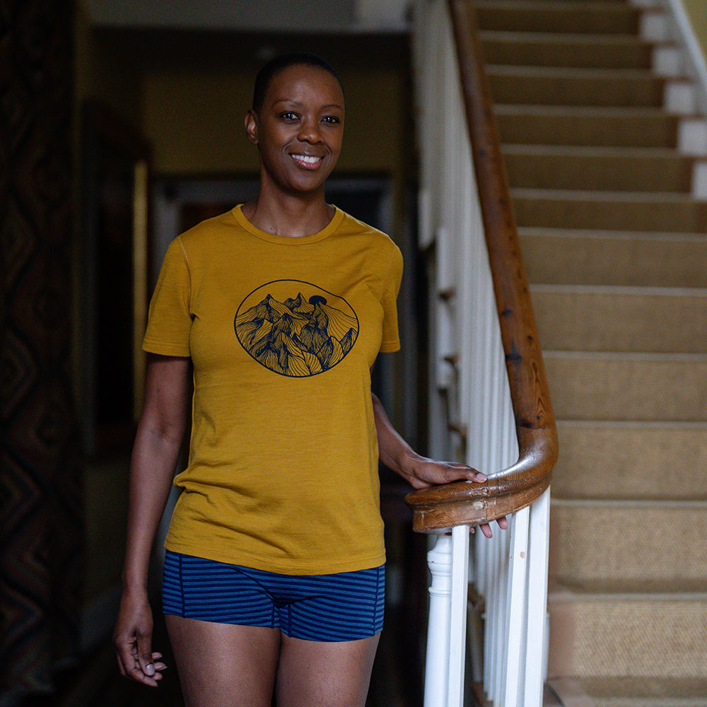 Isobaa | Womens Merino 150 Mountains Tee (Mustard/Navy) | Gear up for adventure with our superfine Merino Tee. | Model: Yolisa
