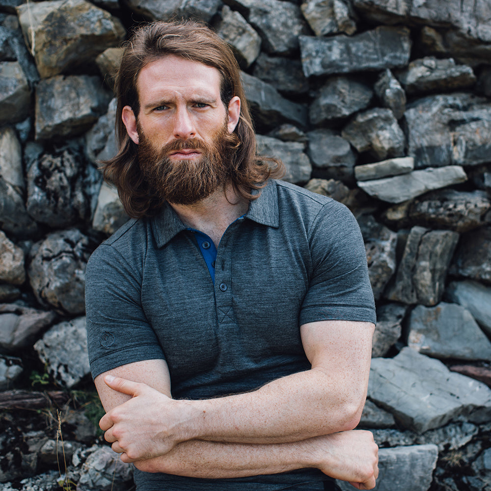 Isobaa | Mens Merino 180 Short Sleeve Polo Shirt (Black) | The ultimate Merino wool polo — perfect for weekend hikes, bike commutes, post-adventure coffee stops, office days, and everything in-between. | Model: Craig