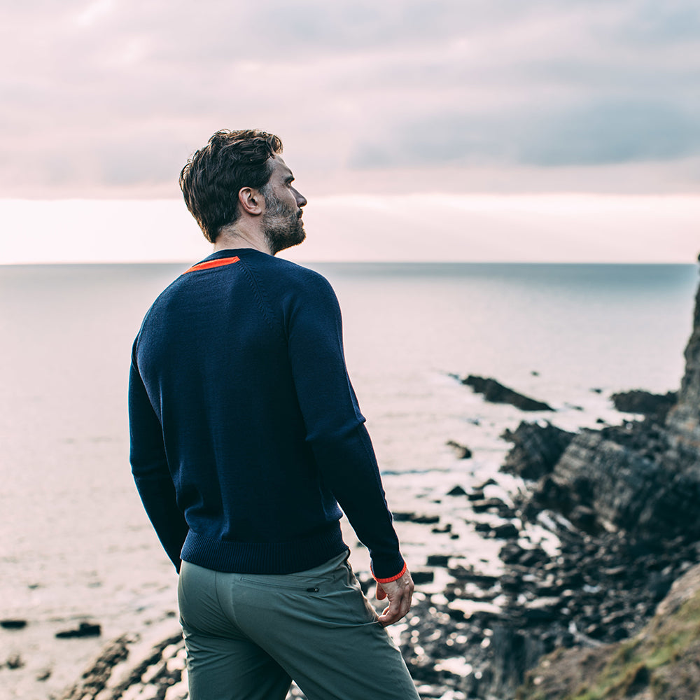 Isobaa | Mens Merino Crew Sweater (Navy/Orange) | Everyday warmth and comfort with our superfine 12-gauge Merino wool crew neck sweater. | Model: Duncan